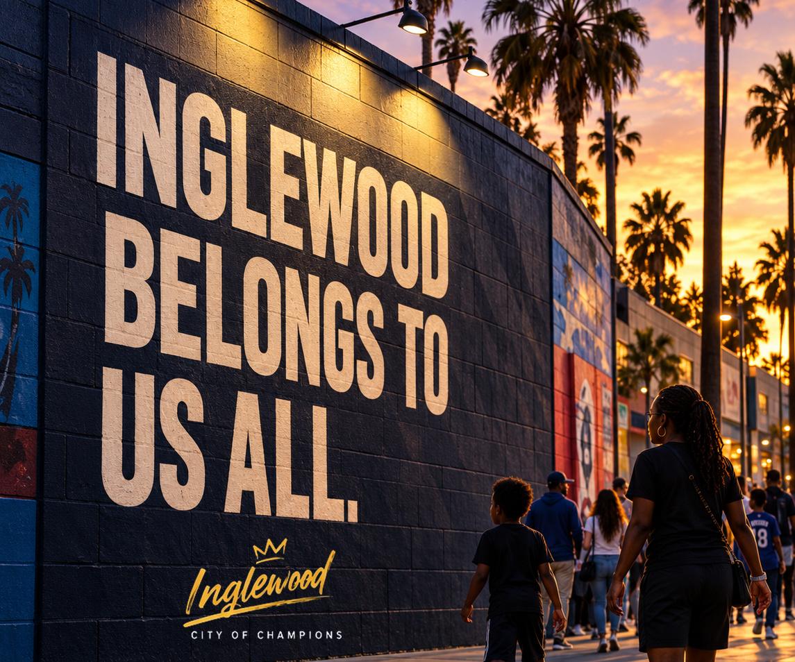 Kids walking past a wall reading INGLEWOOD BELONGS TO US ALL at sunset